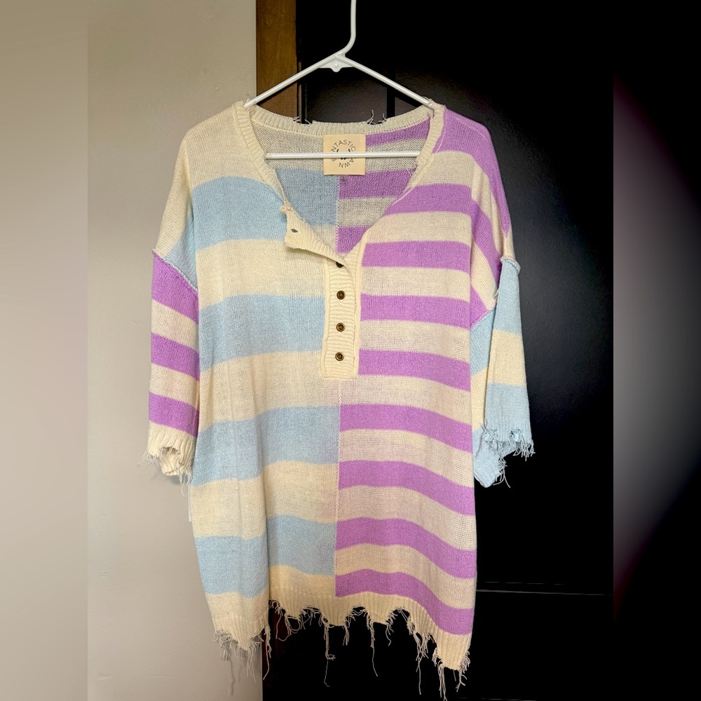 Lightweight distressed sweater, size is large but can fit up to a 1XL.